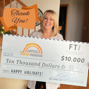 Deb Hypke, administrator at Construction Industry Alliance for Suicide Prevention, accepts the $10,000 donation from Faith Technologies Incorporated.