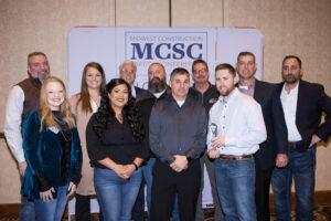 FTI team accepts two safety awards including the Safety Excellence Grand Award from The Builders, A Chapter of the AGC. Pictured in the back row, from left to right: Toby Hunt, FTI project manager; Ashley Albers, FTI regional talent business partner; Curtis Lyles, FTI preconstruction manager; Mat Conaway, FTI project manager; Ryon Weidner, FTI general superintendent; Doug Marr, FTI group leader; Matt Dierking, Builders Association safety, health & environmental director. Pictured in the front row, from left to right: Morgan Morrison, Builders Association safety, health & environmental services office administrator; Itzel Sanjuan, FTI safety intern; Mark Carlson, FTI senior safety manager; Kyle Lang, FTI regional safety manager.