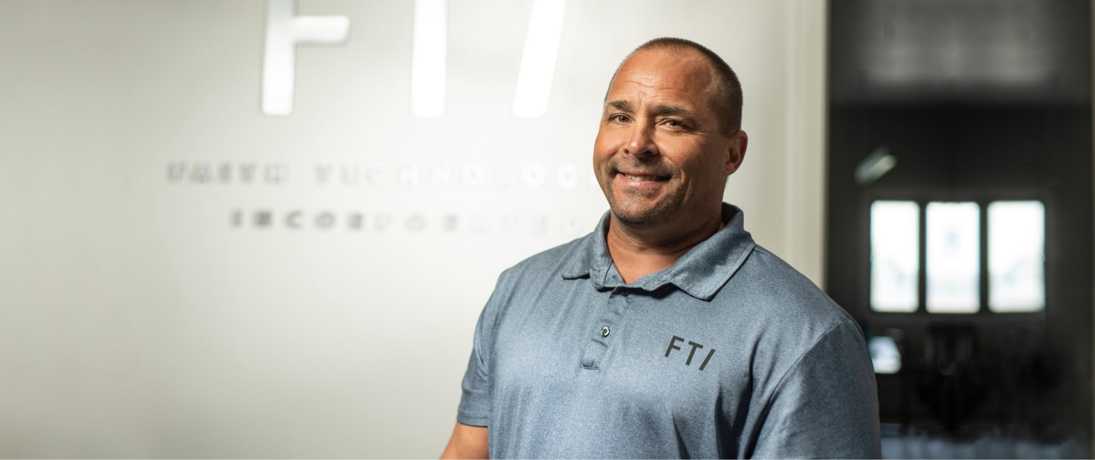 FTI team member smiling in an office