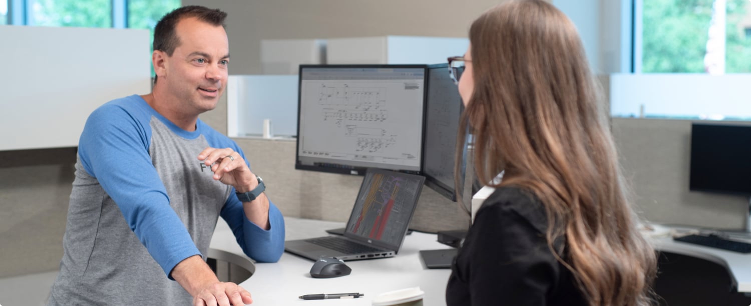 Two FTI team members collaborating in an office