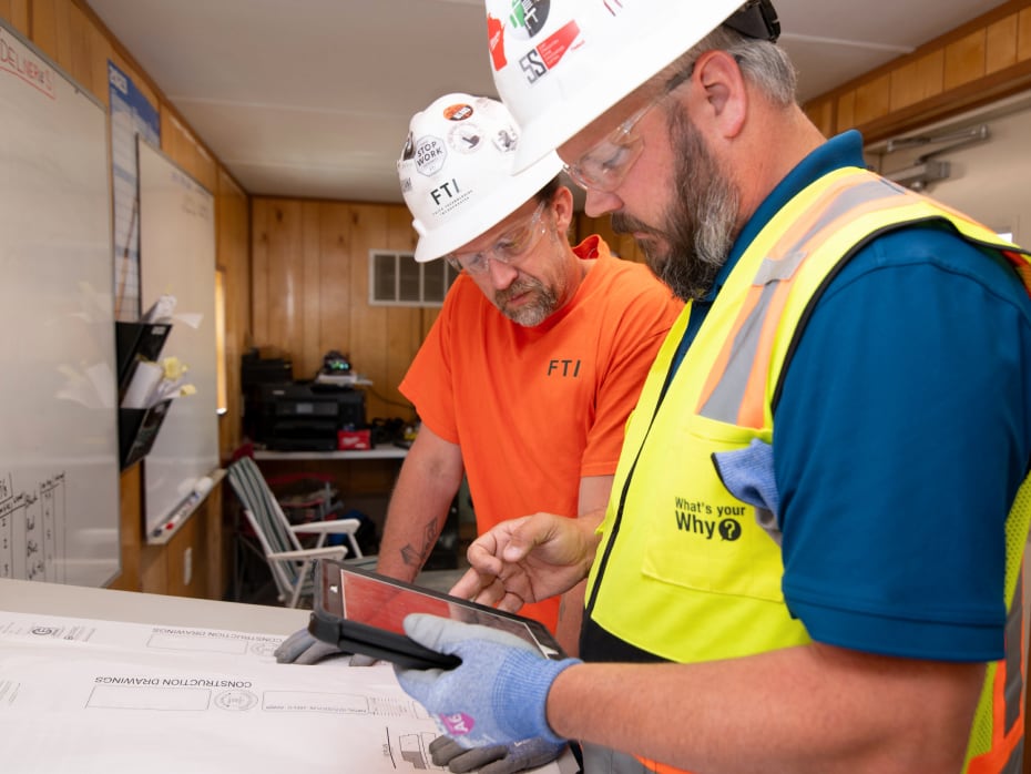 Two FTI team members collaborating on jobsite