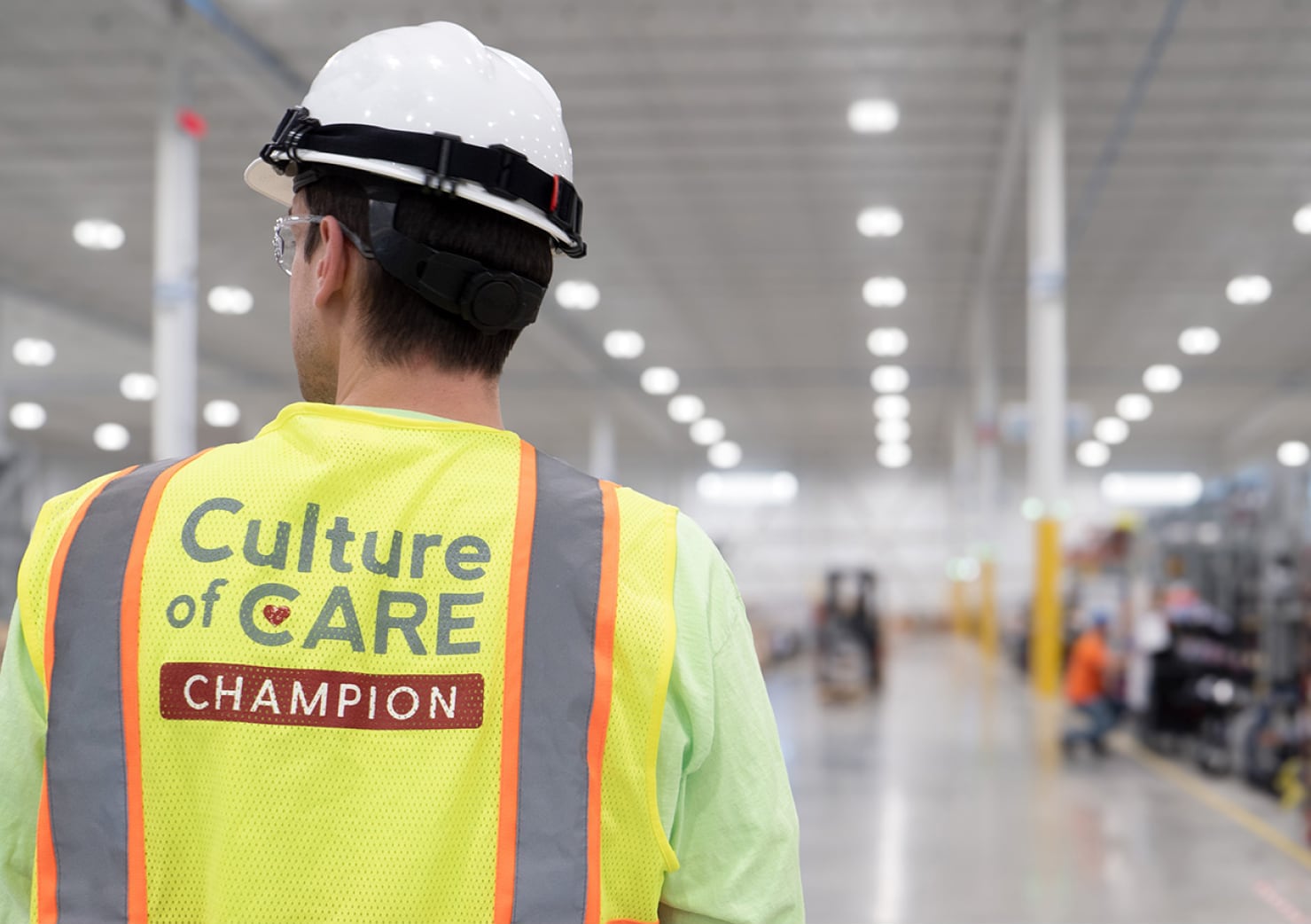 FTI team member with his vis Culture of Care Champion vest