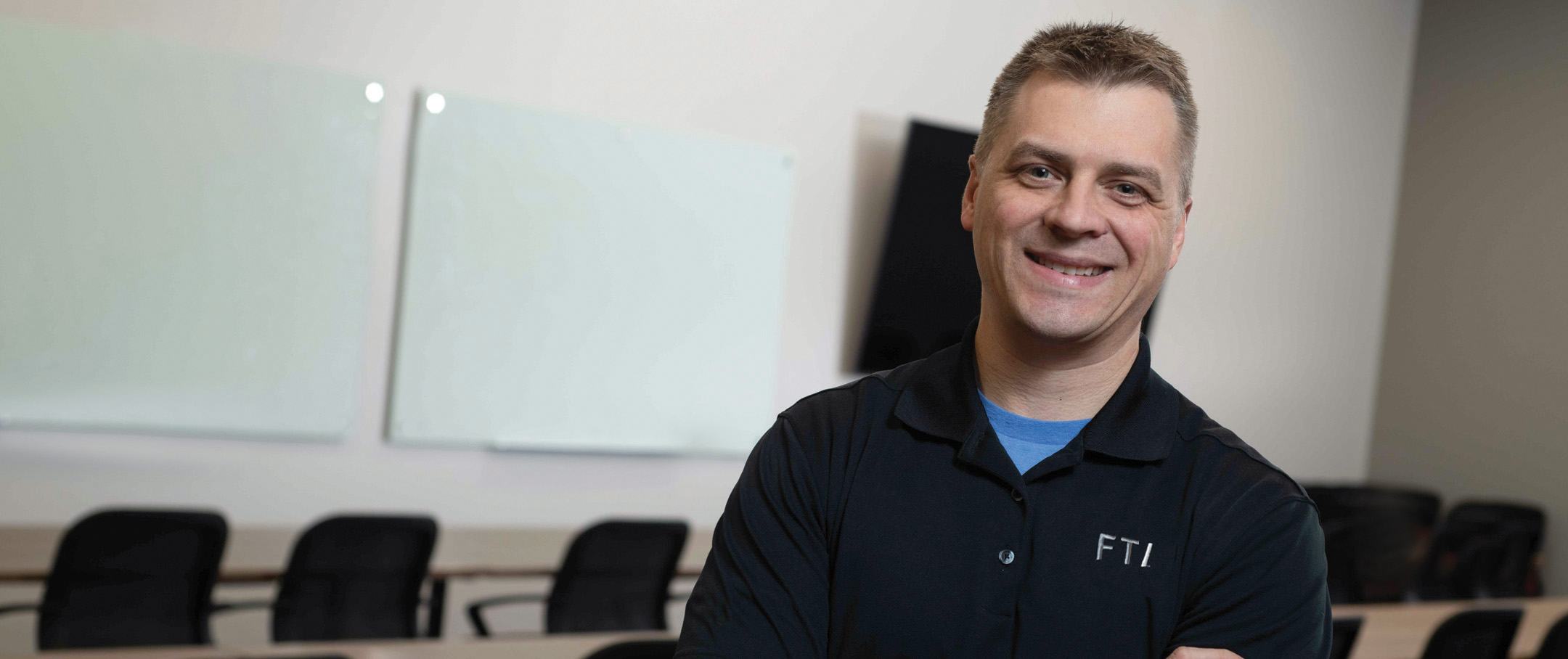 FTI Team Member Smiling in Training Room
