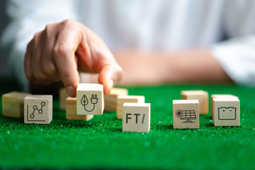 Hand moving blocks with FTI's Path to Smarter Energy icons