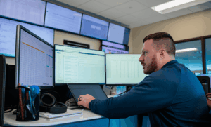 FTI team member working on computer in the Network Operations Center