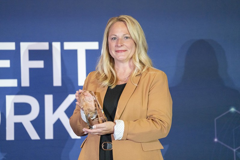 Joanne Homa, FTI team member, accepts Employee Benefit News award.