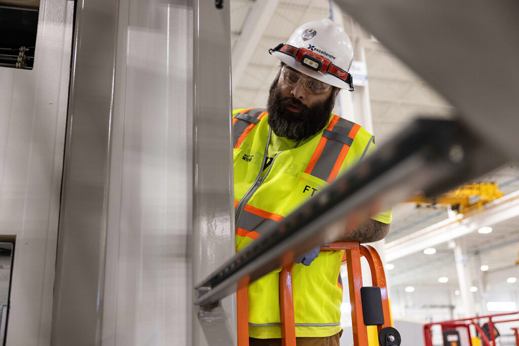 FTI team member working at Excellerate manufacturing facility.